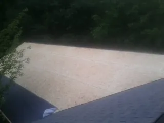 New OSB roof sheathing installed beside an existing shingle roof in Santa Fe Springs